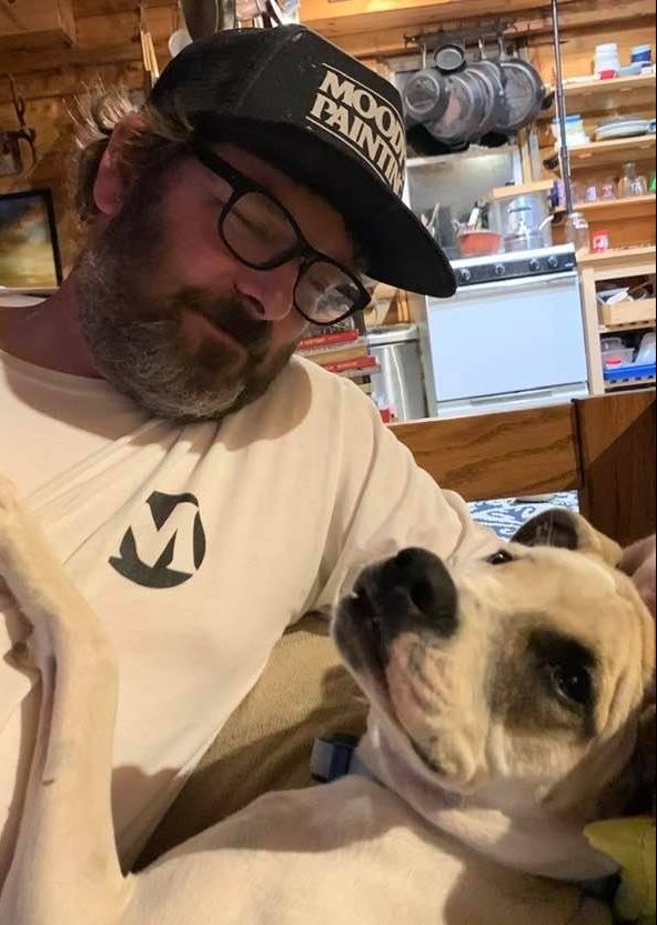 Joshua Moody, owner of Moody's Painting & Fine Finishes, and his dog.